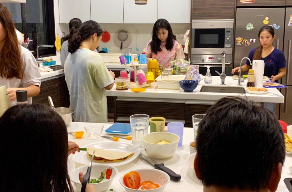 The family and our helper cooking dinner together