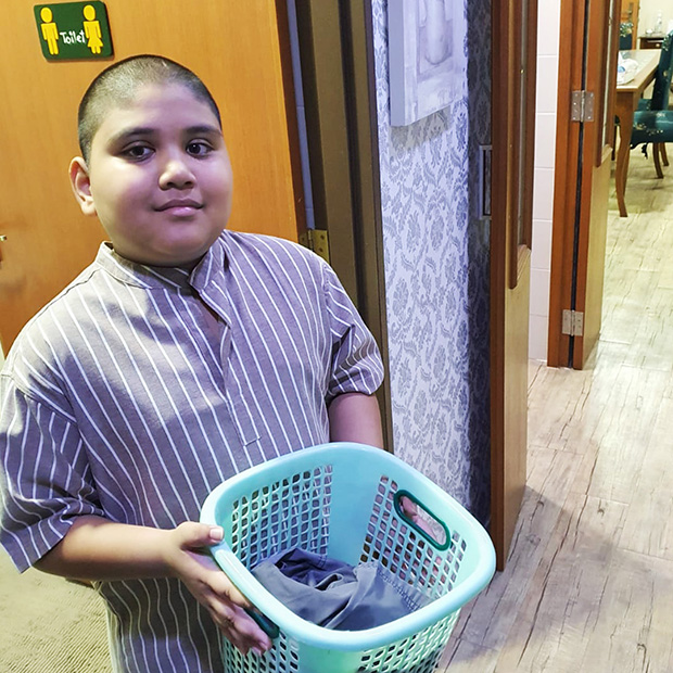 Kavi helping with the laundry.