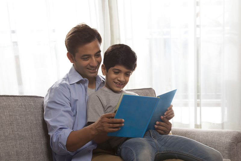 father and child reading together